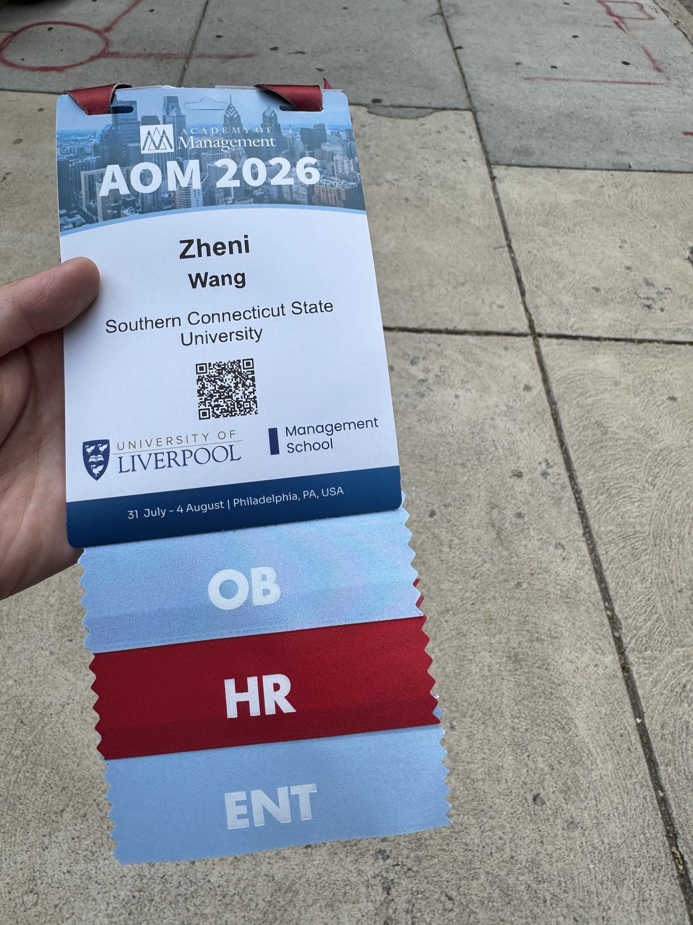 Conference badge with OB, HR, and ENT division ribbons — AOM 2026, Philadelphia